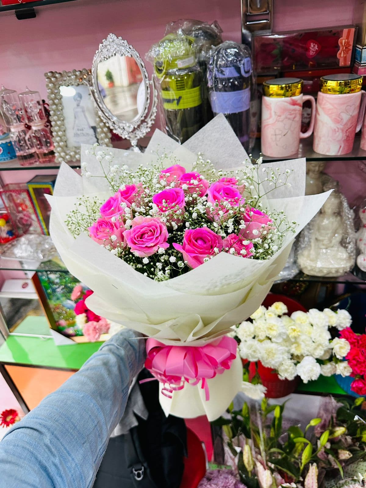 Hot pink roses and baby's breath in white wrapping